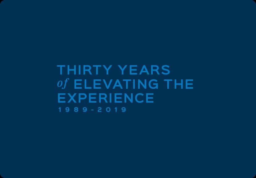 A blue background with the words "thirty years of elevating the experience" showcases the product title