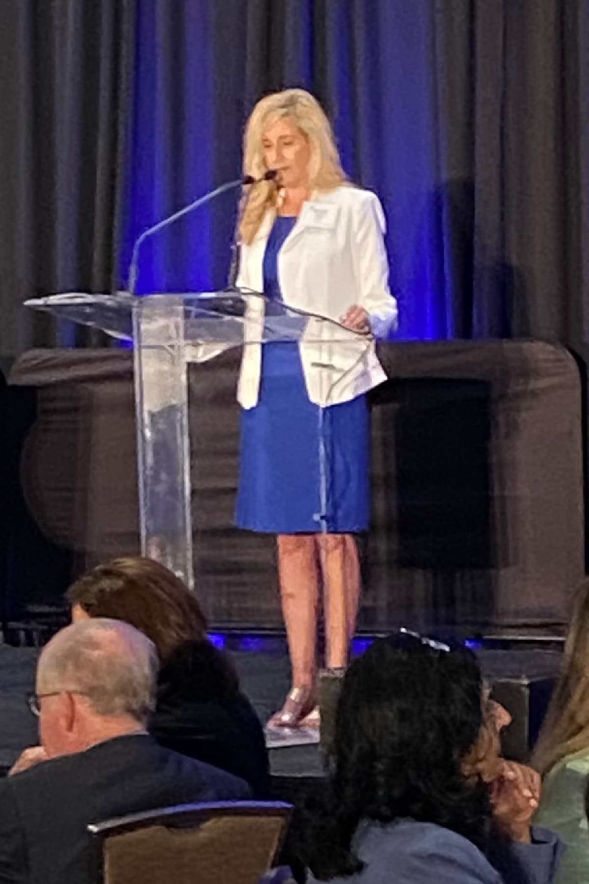 Tina giving a speech at a podium