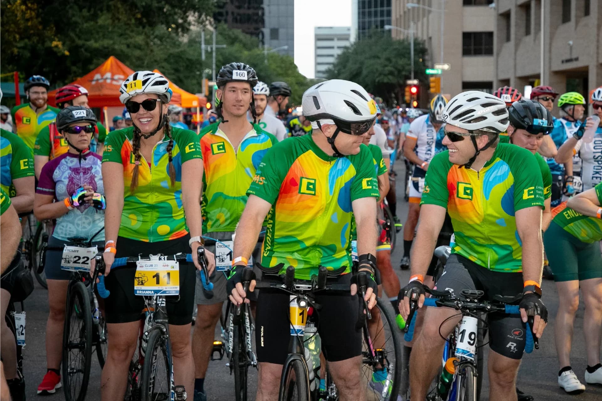 A group of men riding bikes down a street