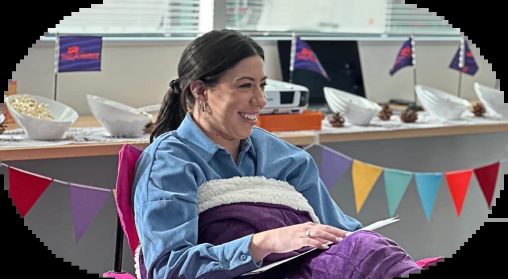 a woman sitting in a purple chair in an office