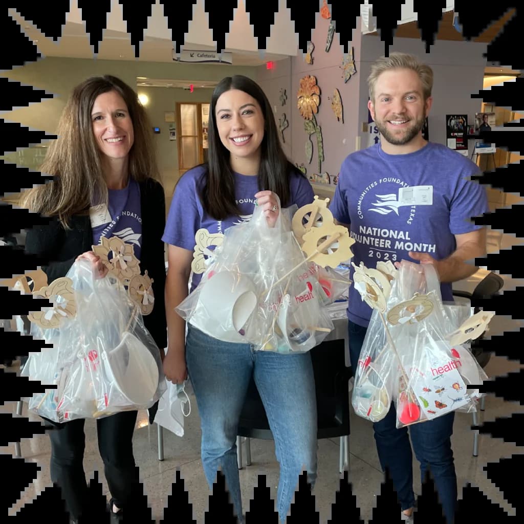 A group of people holding bags of cookies