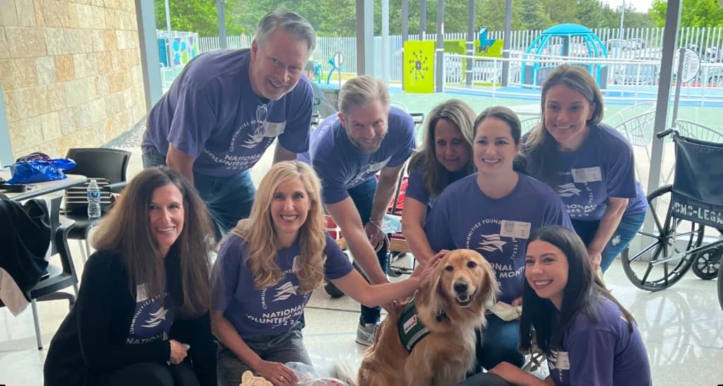 a group of people posing for a picture with a dog