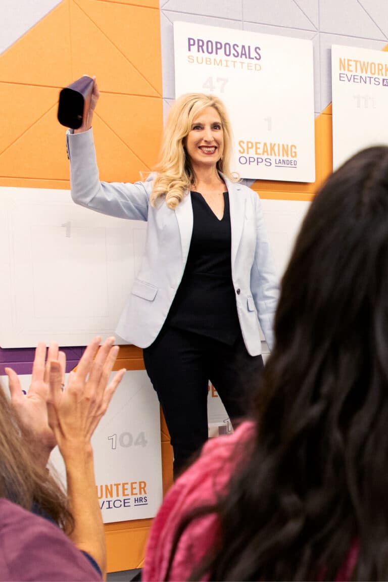 a woman standing in front of a group of people