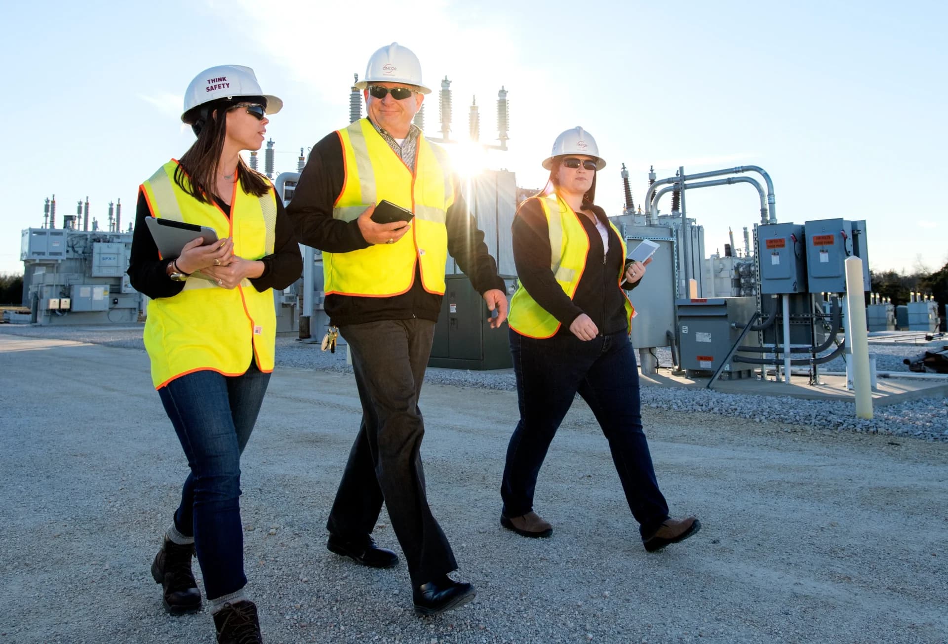 A group of people in safety vests and hard hats