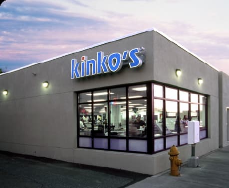 a yellow fire hydrant in front of Kiniko's restaurant