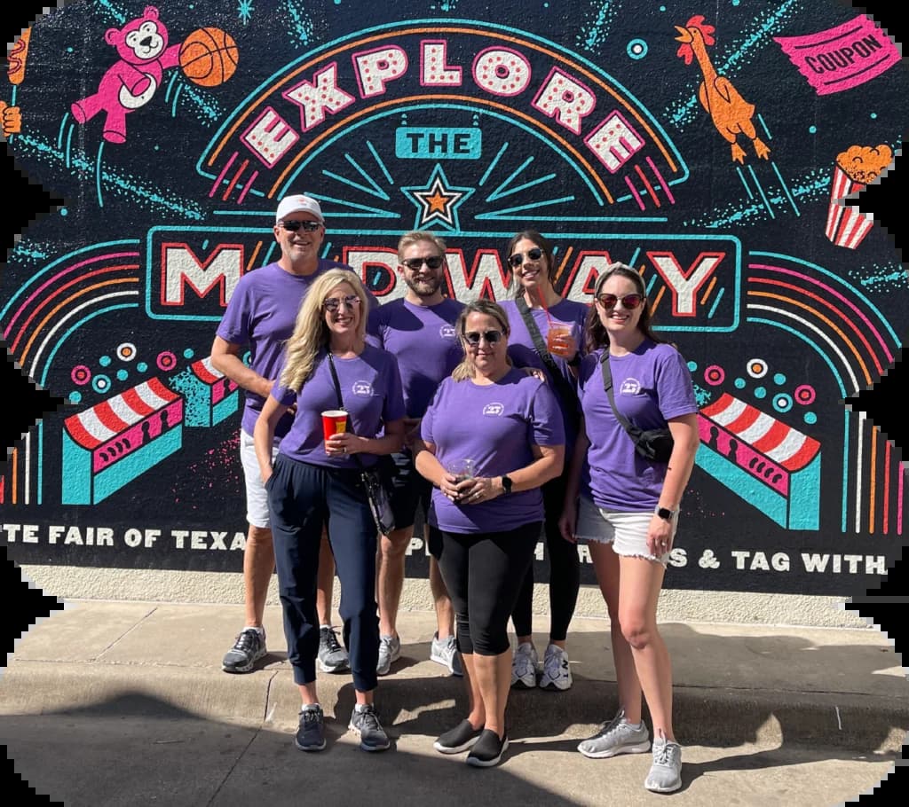 a group of people in purple shirts posing for a picture