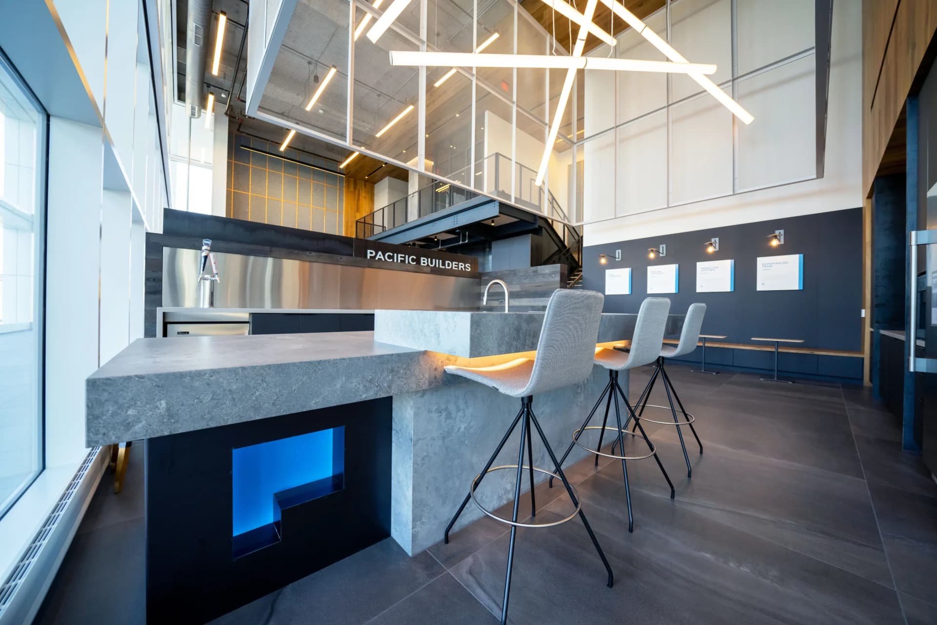 A kitchen with a counter and chairs in it