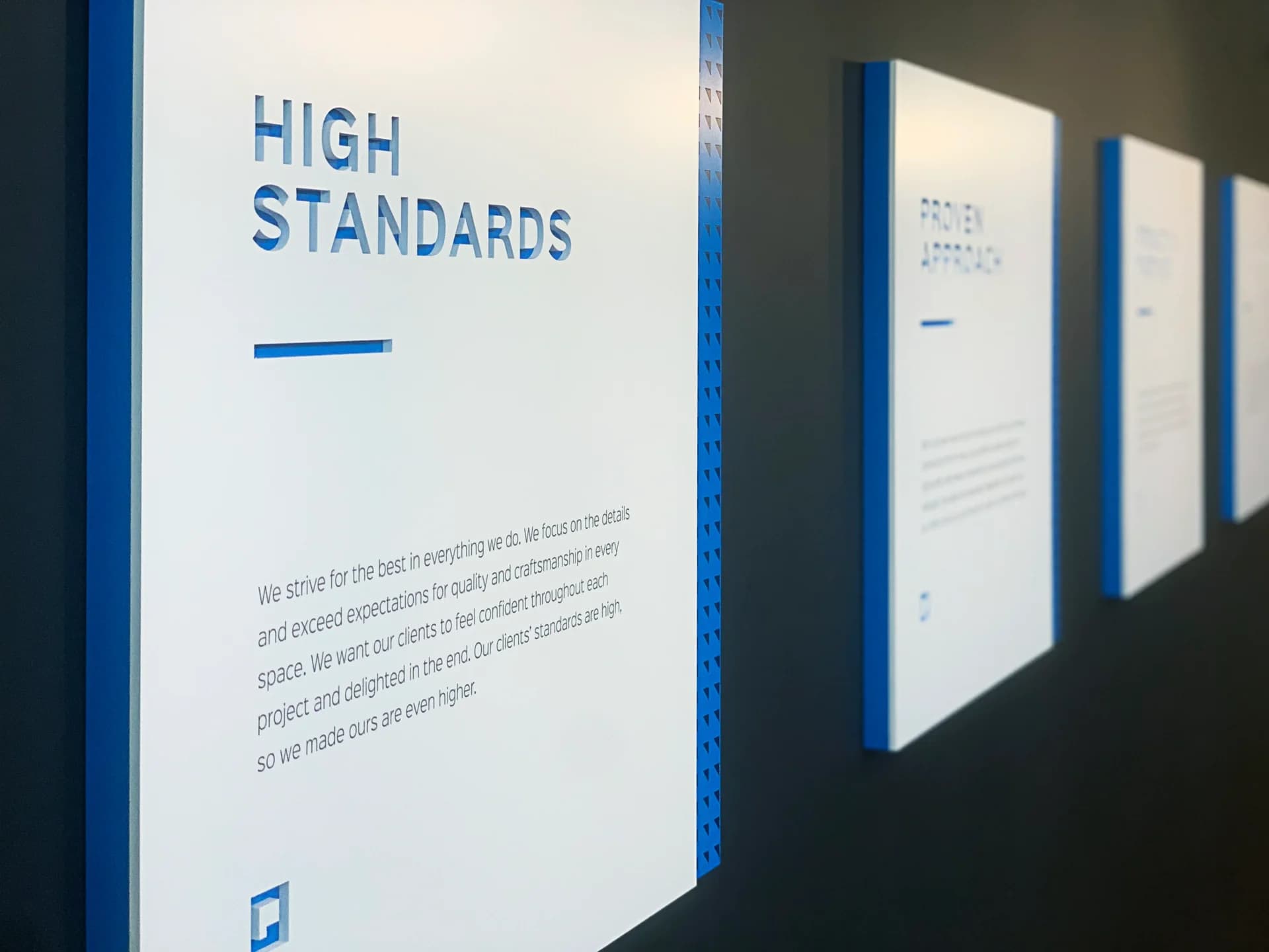 A row of blue and white signs on a wall