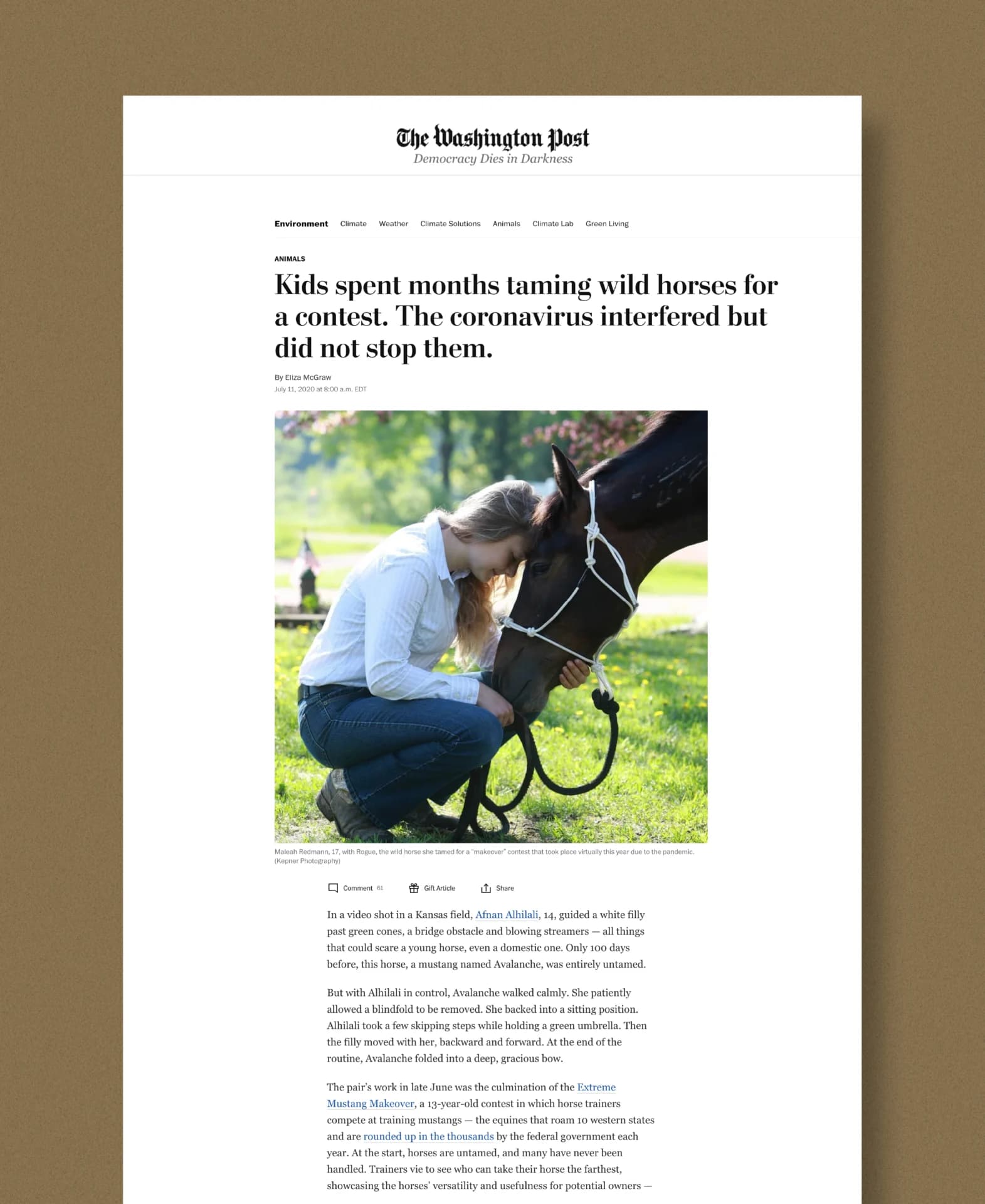 a woman kneeling down next to a horse